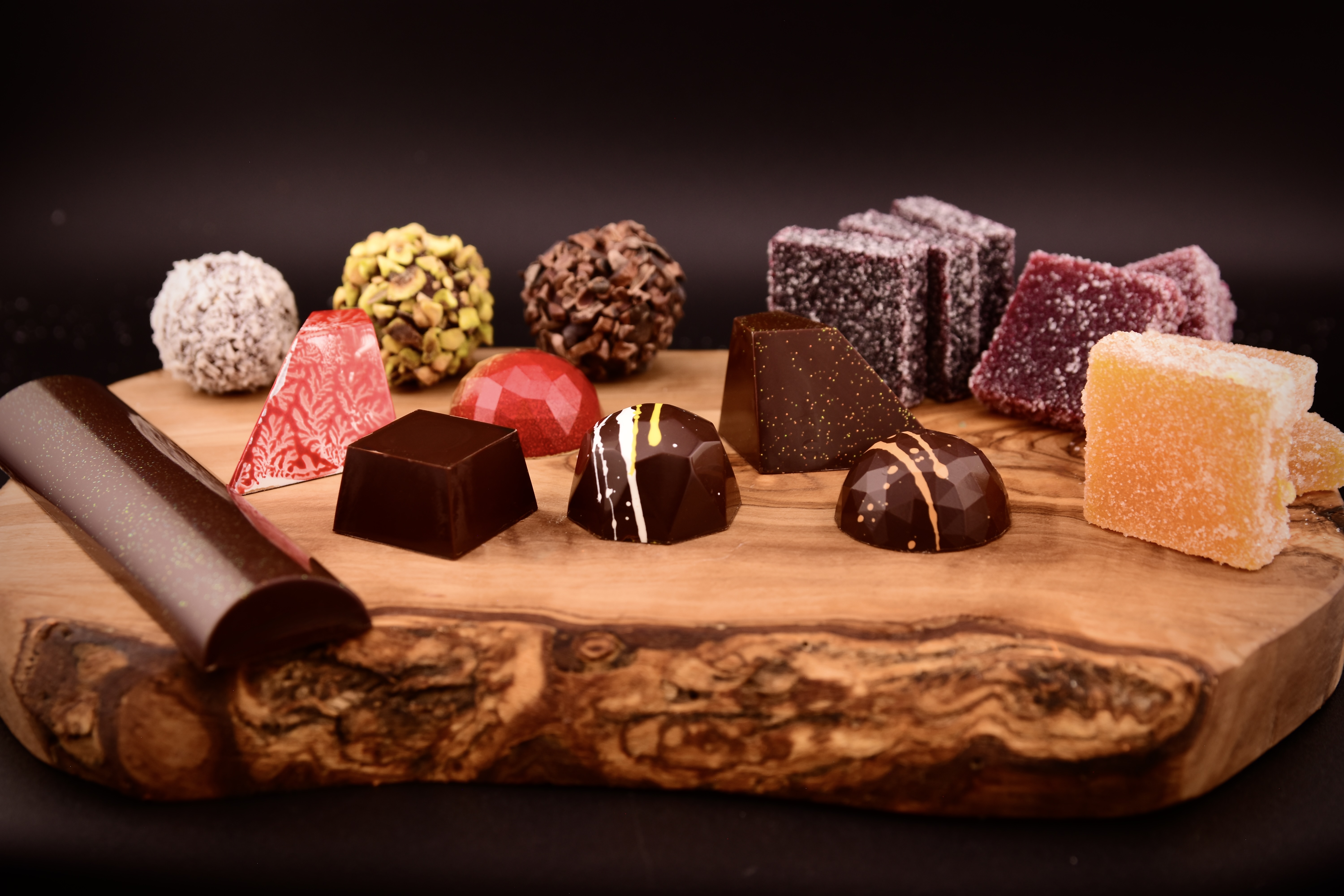 Alpen bonbons, truffles, and pâte de fruit on a wooden board